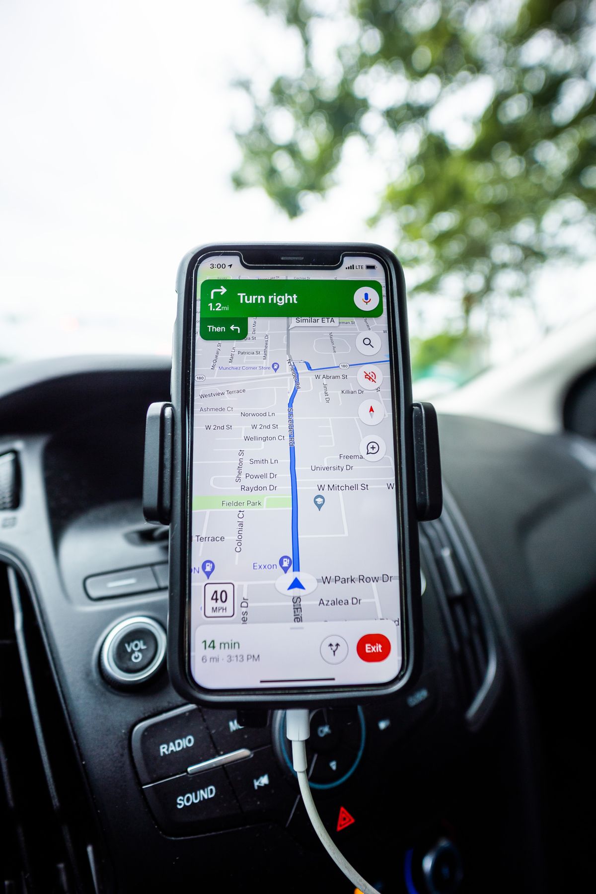 Phone showing a navigation route, mounted in a vehicle